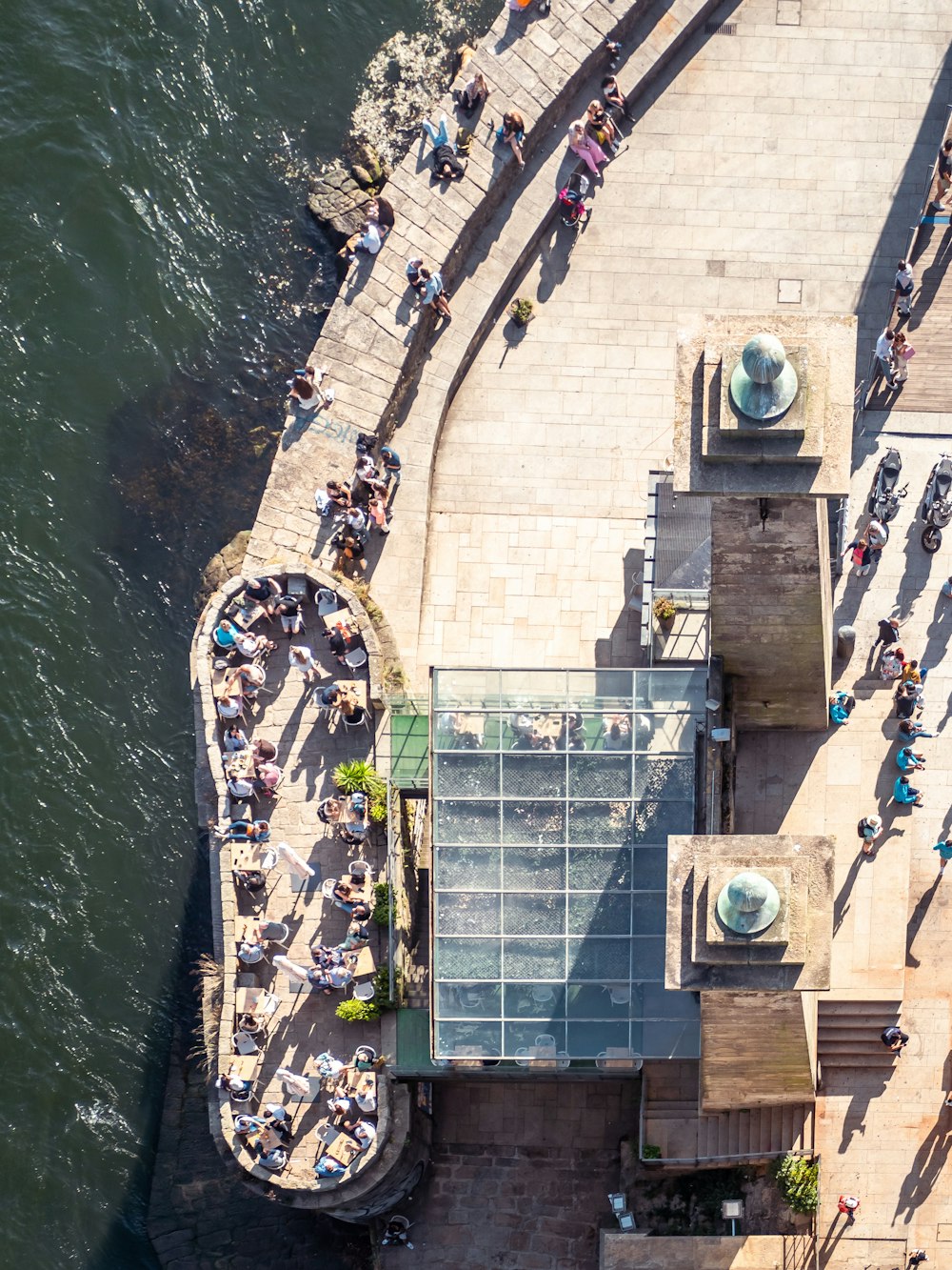 a group of people standing on the side of a river