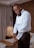 A man wearing a sleek ring while adjusting his cufflinks.