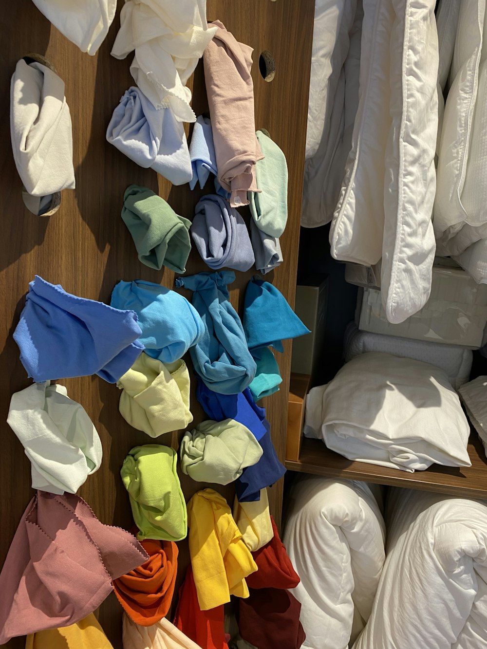 a closet filled with lots of different colored shirts