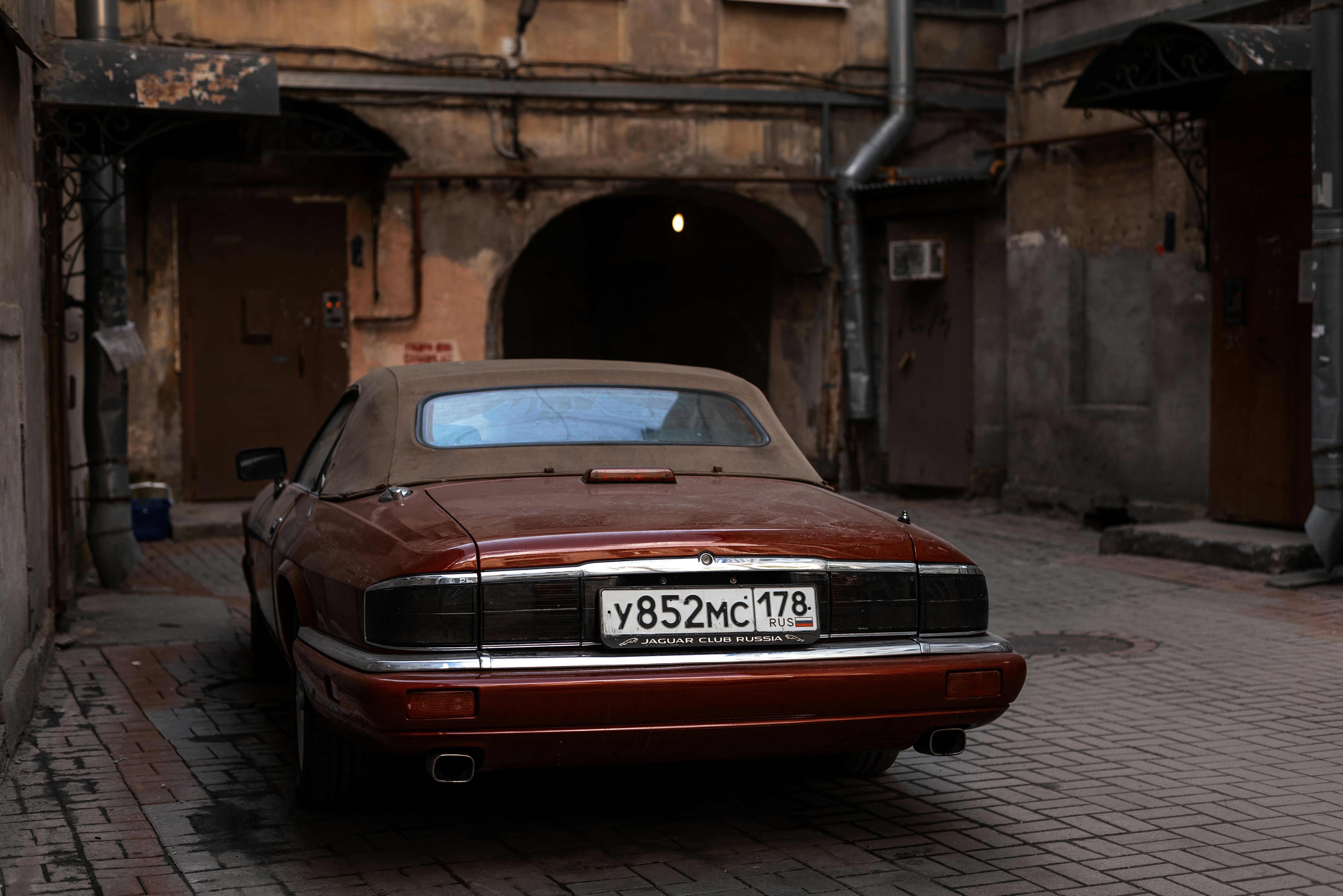 A car parked on a brick street in front of a building photo – Free Car ...