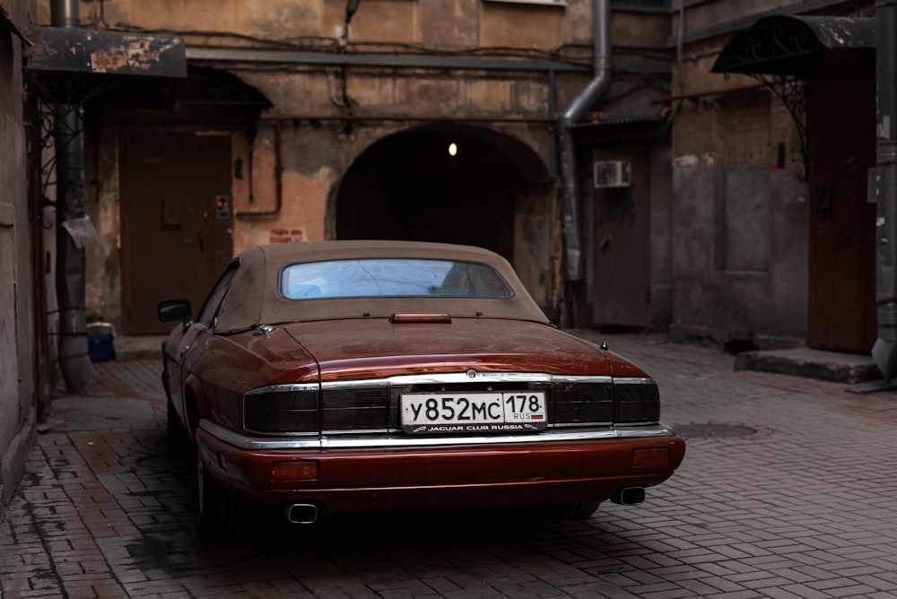 a car parked on a brick street in front of a building