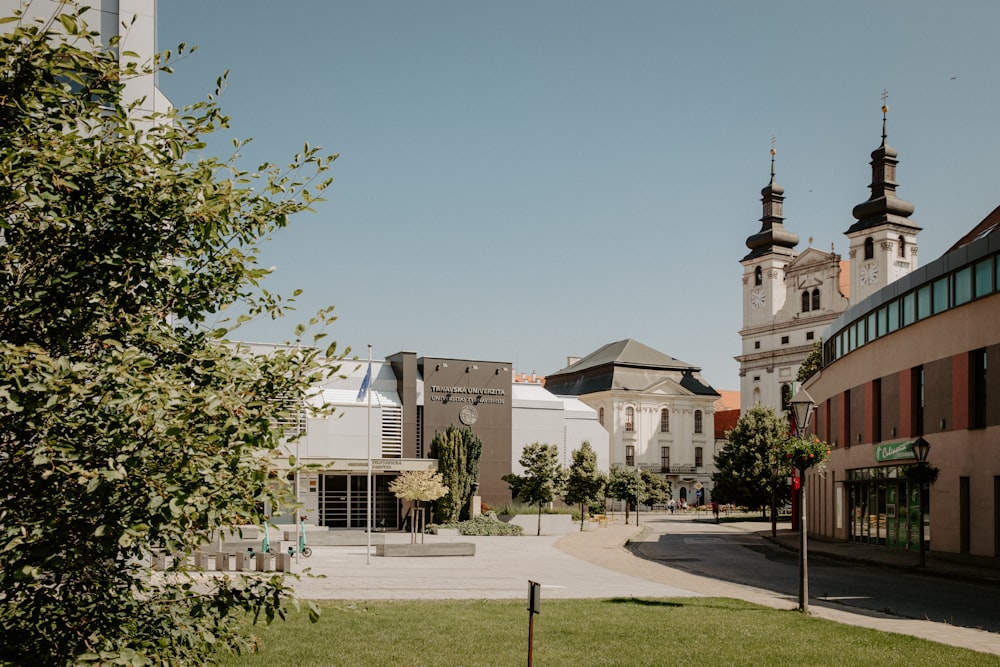 a city street with buildings and a clock tower in the background