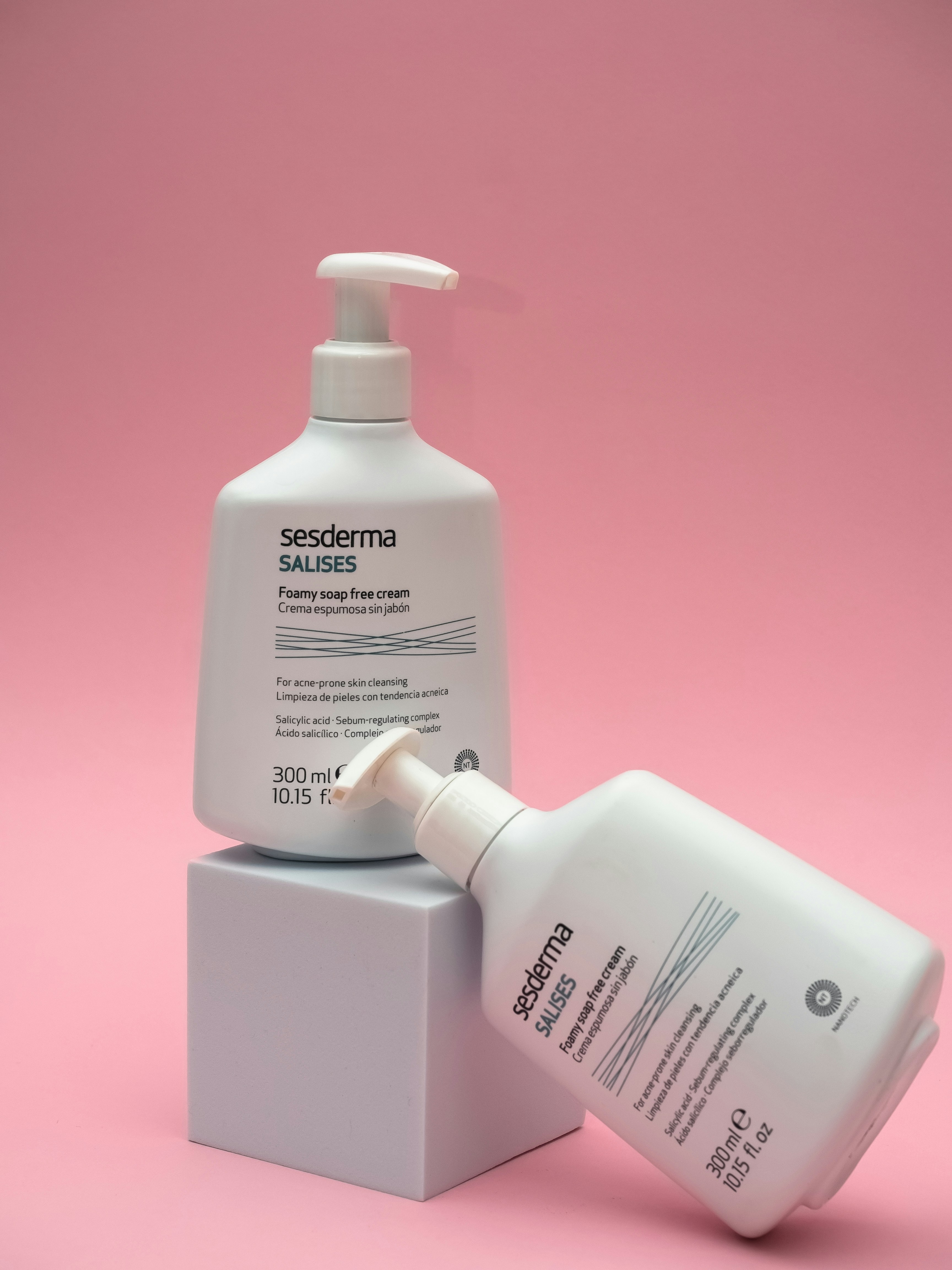 a bottle of hand sanitizer next to a container of hand sanitizer