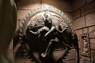 Close-up of an intricately carved deity statue bathed in soft sunlight