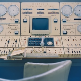 a control panel with a bunch of clocks on it