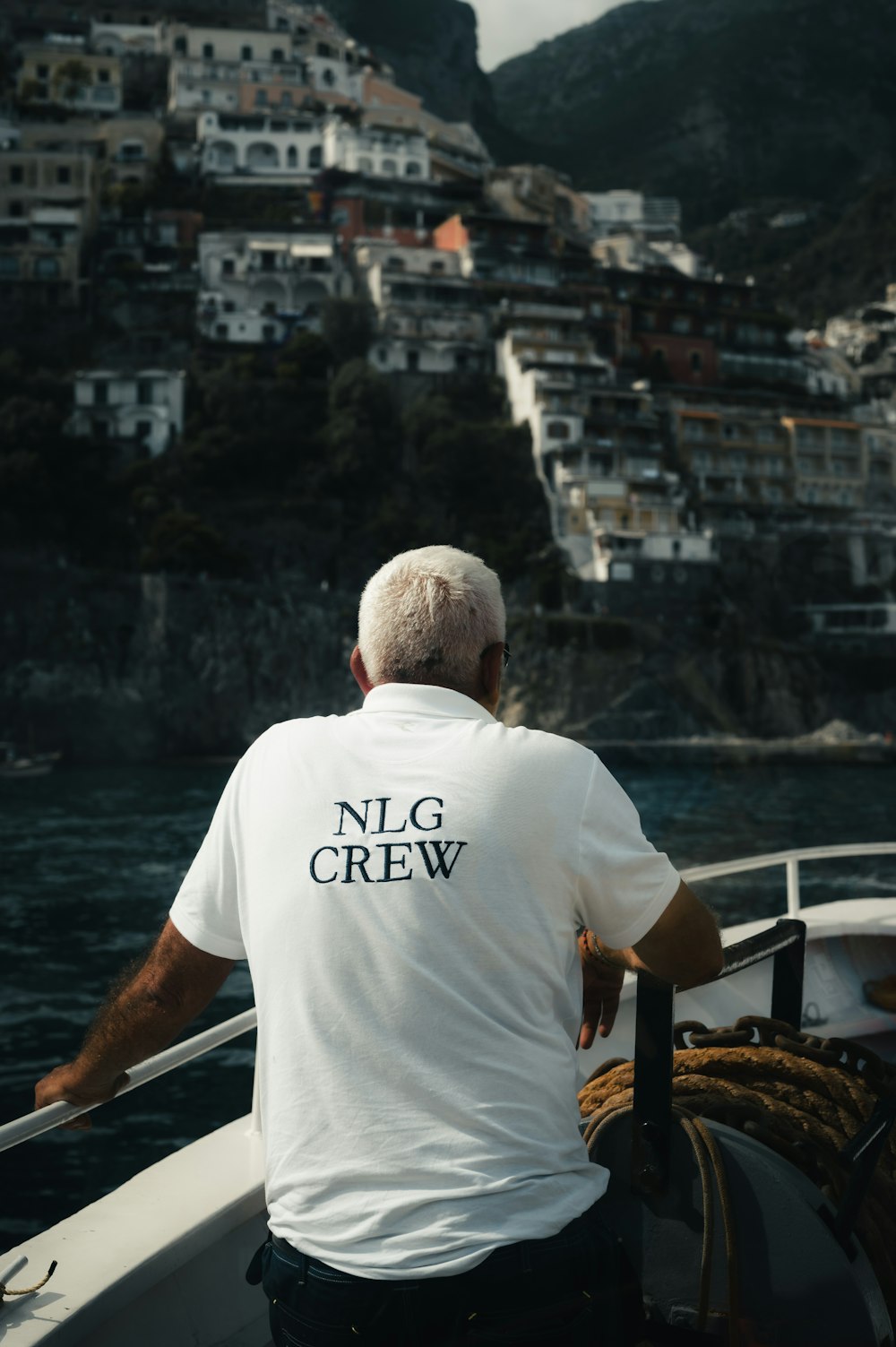 a man in a white shirt is on a boat