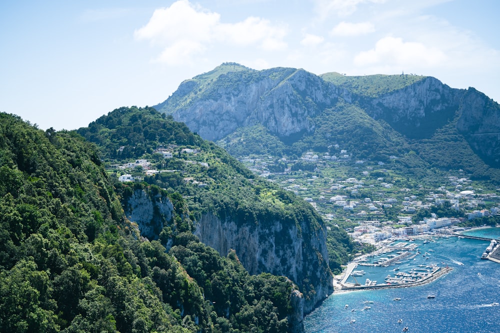 a scenic view of a bay with boats in the water and mountains in the background