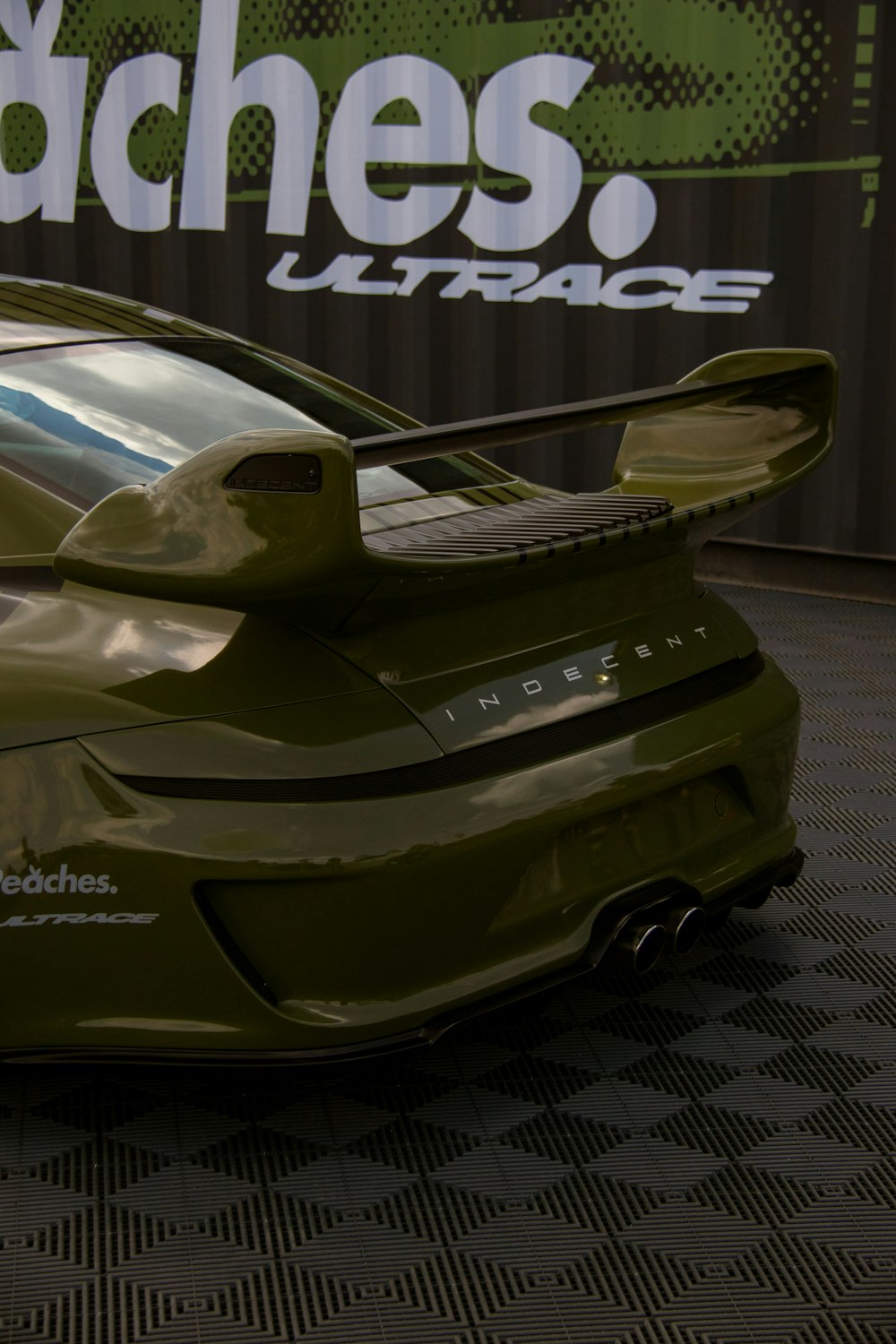 a green sports car parked in a garage