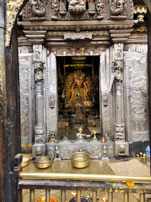 Devotees offering flowers and prayers inside a serene temple courtyard.