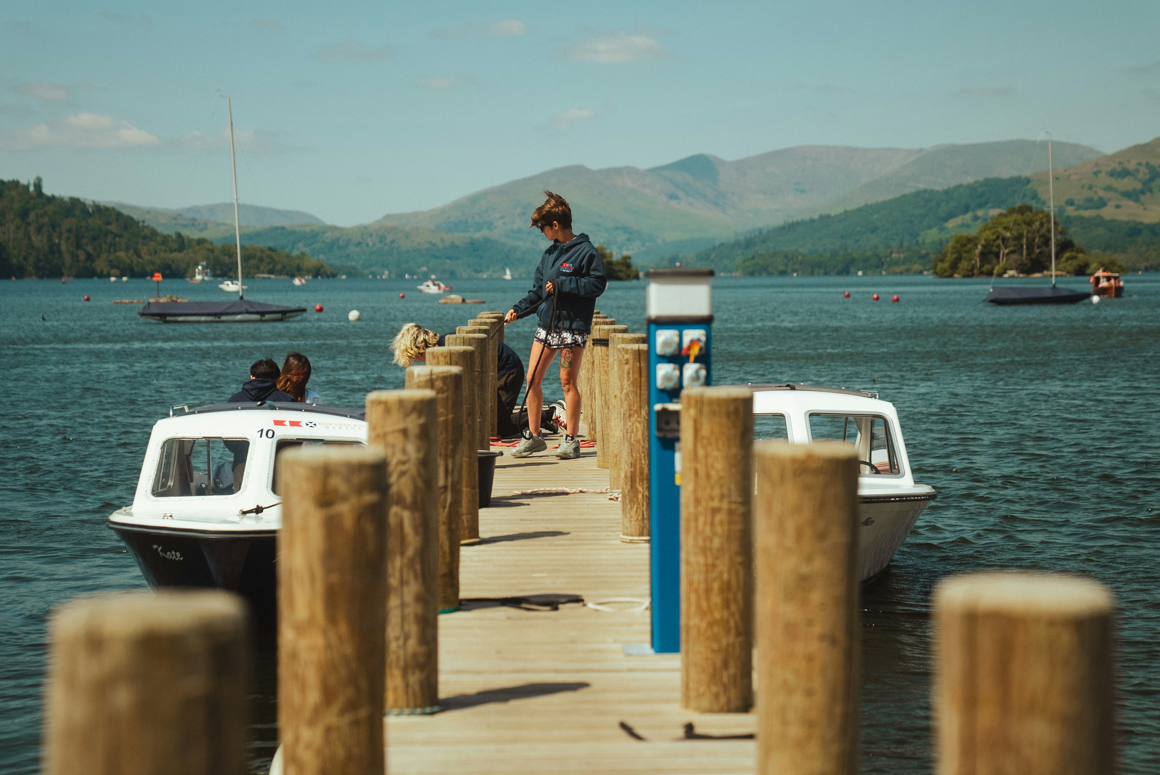 a man standing on a dock next to a boat