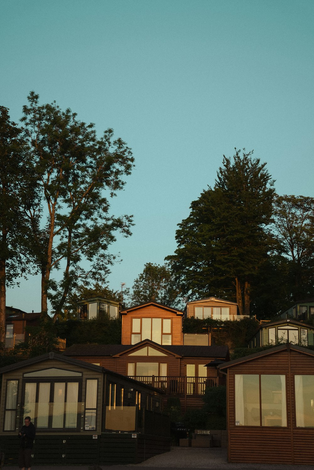 a couple of houses sitting on top of a hill