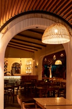 Cozy rustic interior of Noble Campo restaurant with wooden tables and warm lighting.