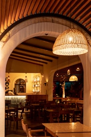Warm, inviting interior of Michozita with elegant wooden tables and soft lighting reflecting a modern Ecuadorian ambiance.