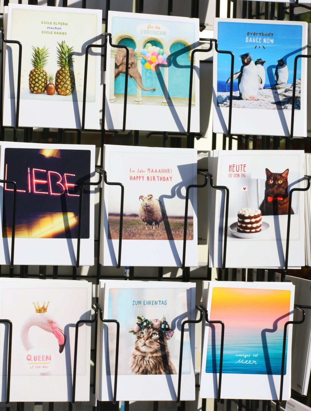 a bunch of greeting cards hanging on a wall
