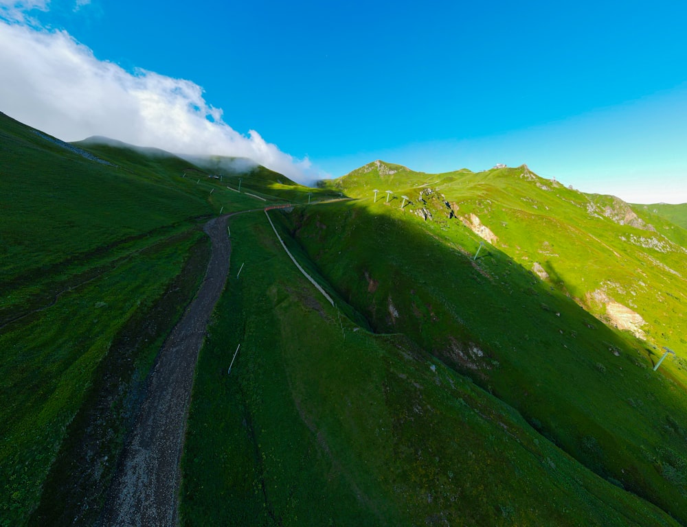 an aerial view of a green mountain side