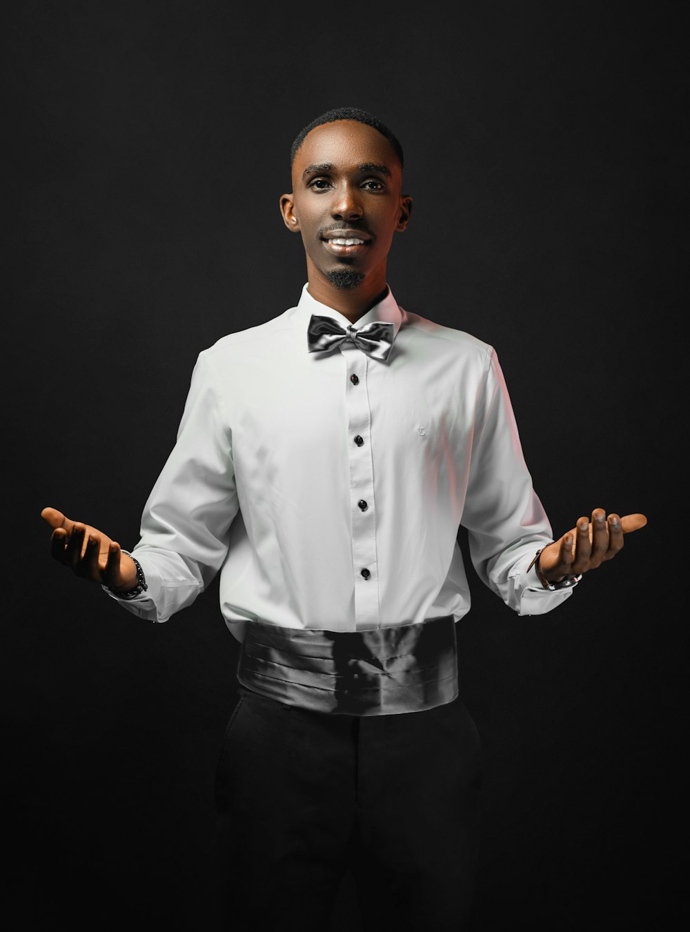 a man in a white shirt and bow tie