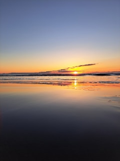 An ethereal sunset over a calm ocean, symbolizing peace.