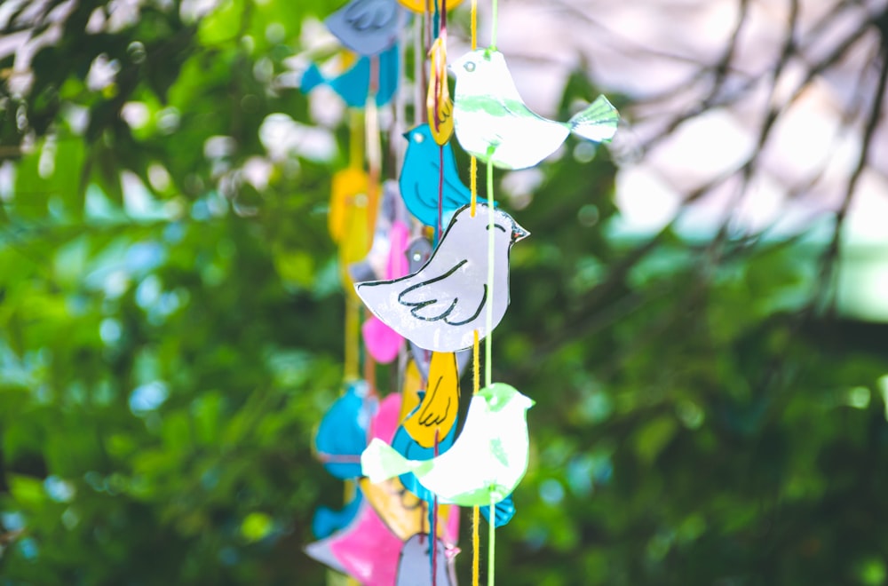 a colorful wind chime hanging from a tree