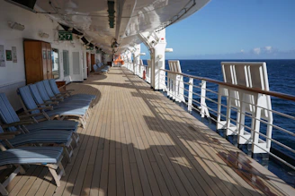 A vibrant deck scene with passengers enjoying a lively outdoor game under a clear blue sky.