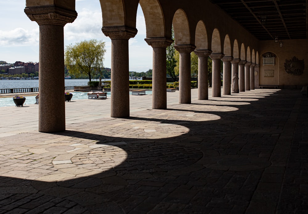 a row of pillars sitting next to a body of water