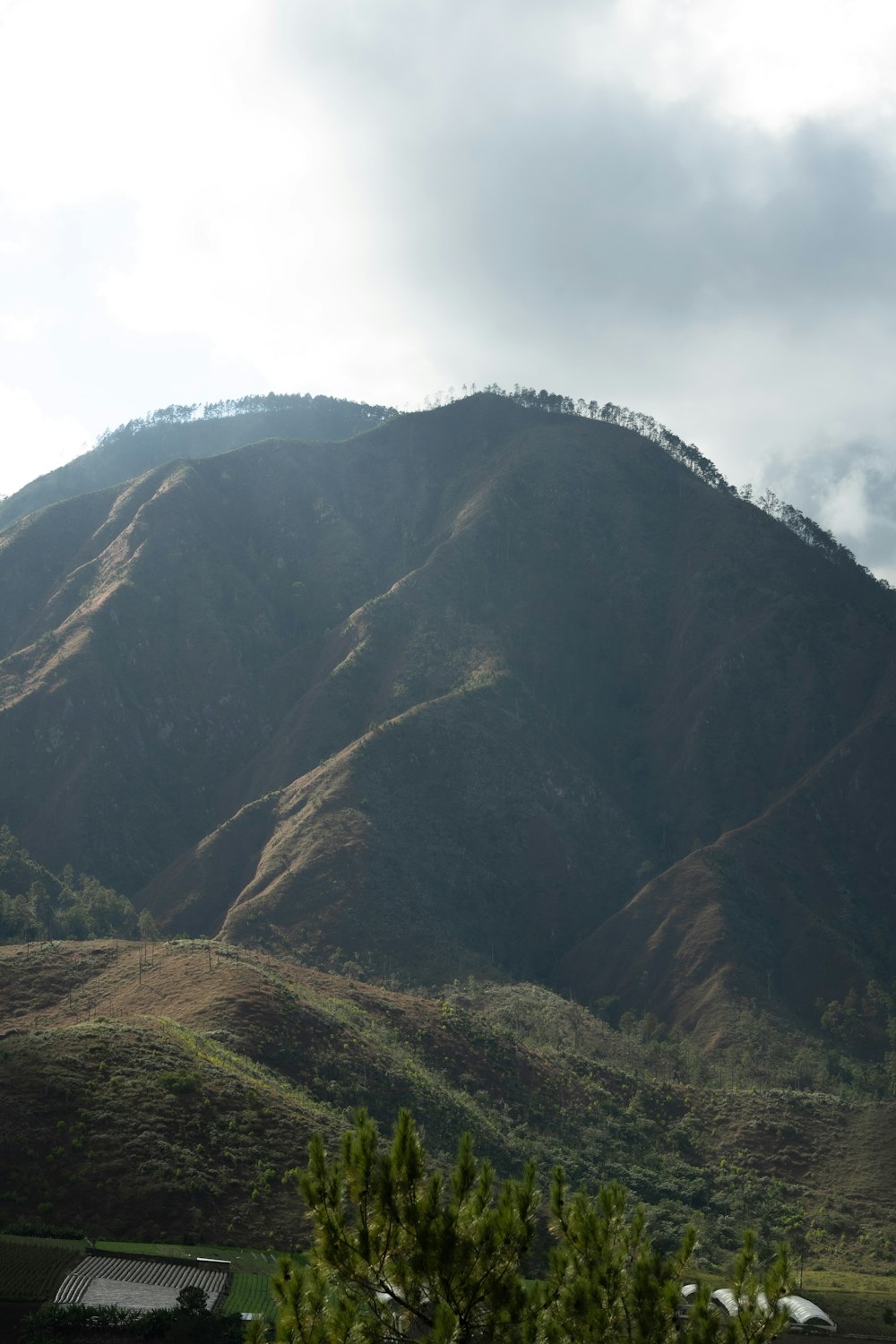 a view of a mountain with a house in the foreground