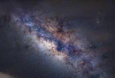 A vibrant galaxy cluster swirling with stars and cosmic dust, symbolizing the vastness of space.