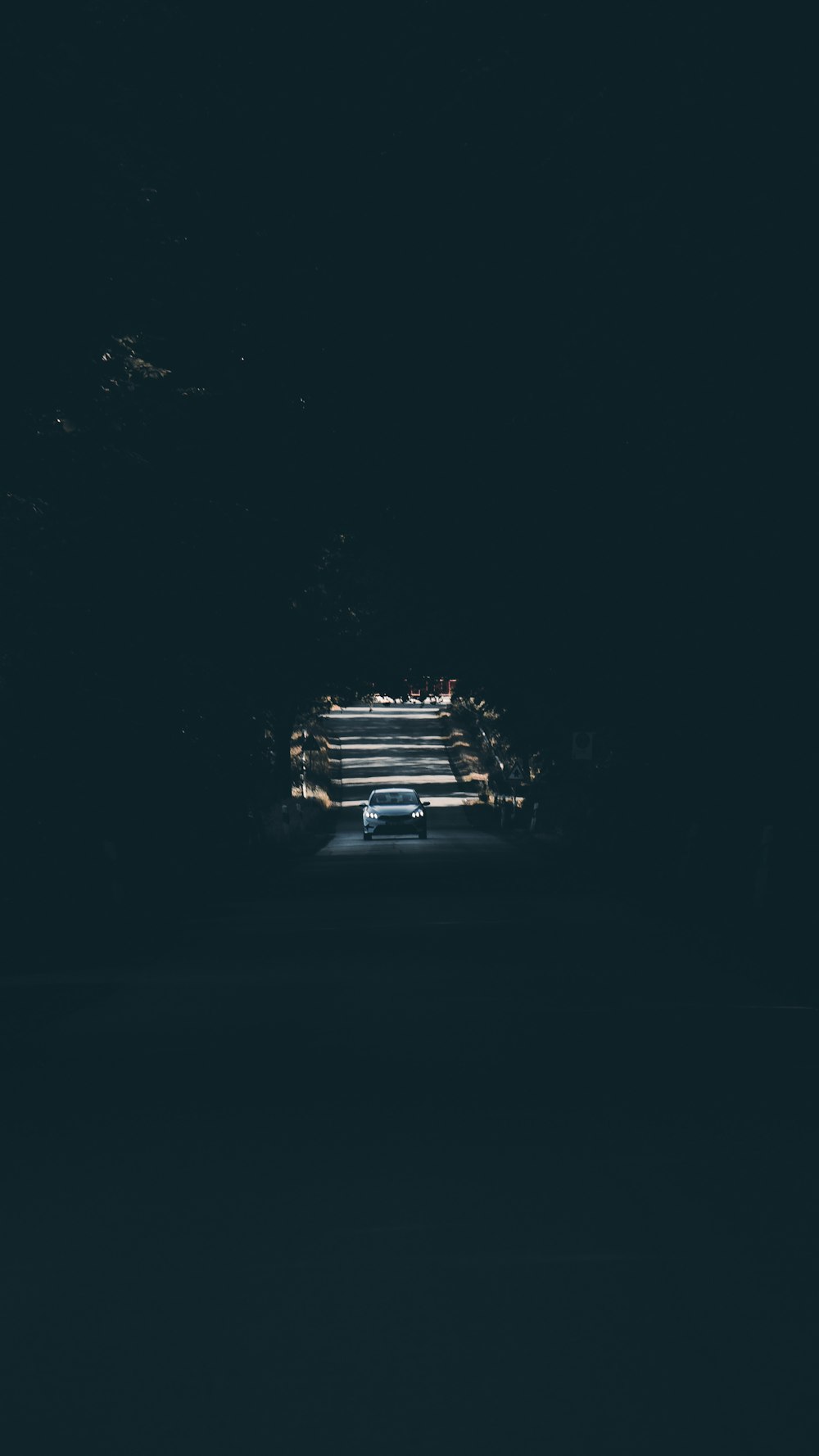 a car driving through a tunnel in the dark