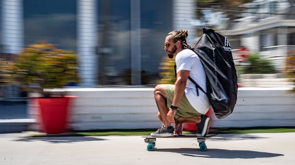 a man riding a skateboard down a sidewalk