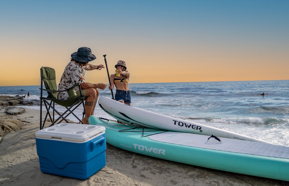 a couple of people that are sitting on some surfboards