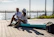 Couple enjoying drinks on the spacious deck of the boat surrounded by turquoise waters.