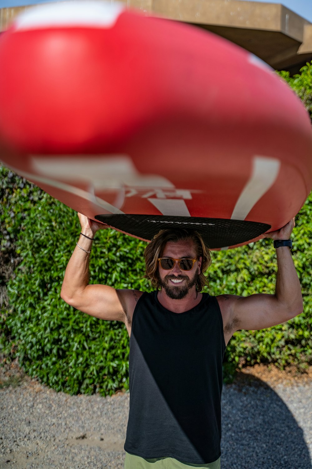 a man holding a surfboard on his head