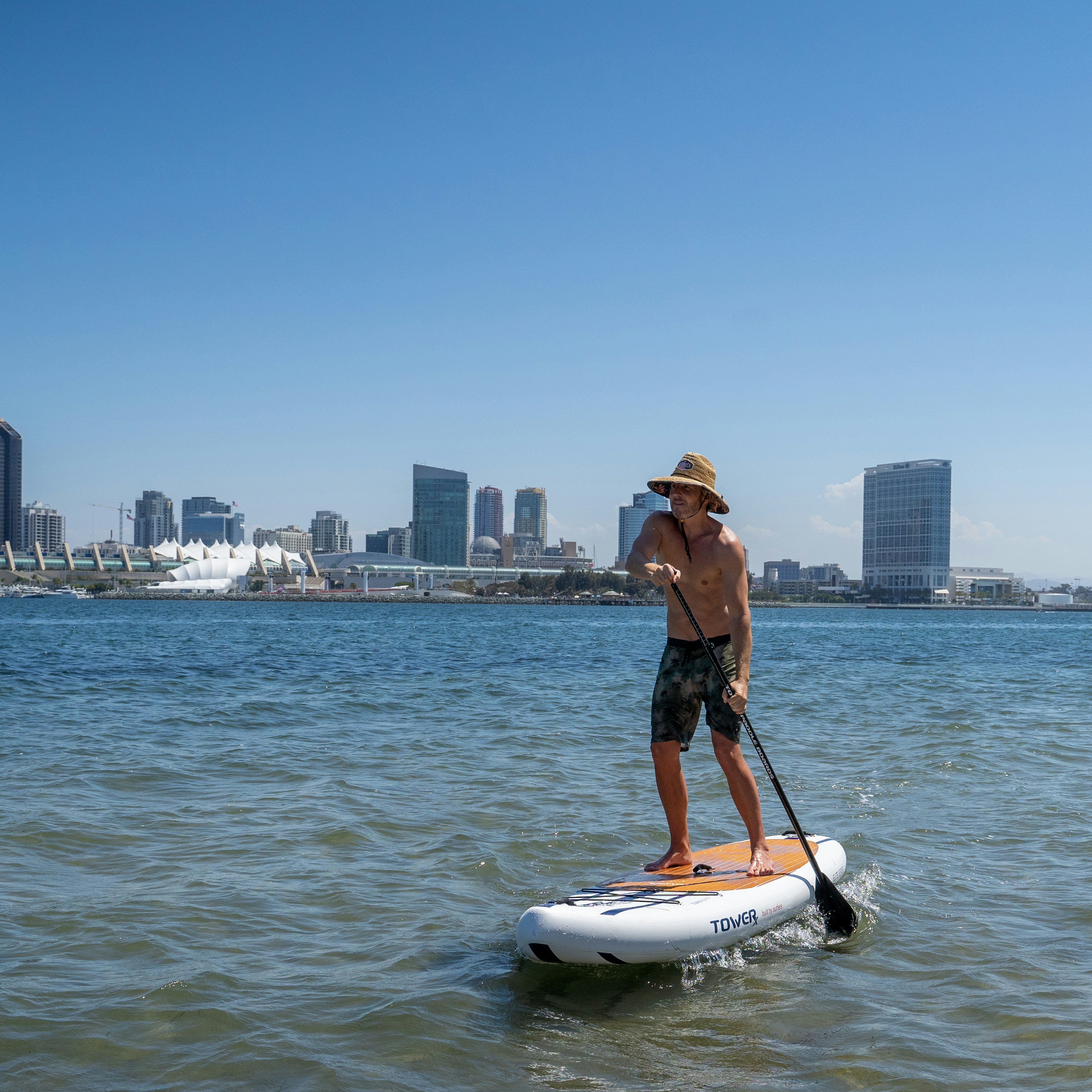 a man riding a paddle board on top of a body of water