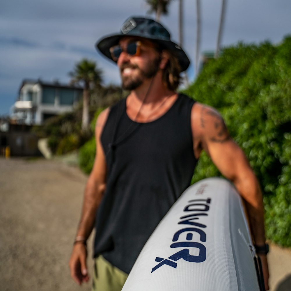 a man holding a surfboard on the beach
