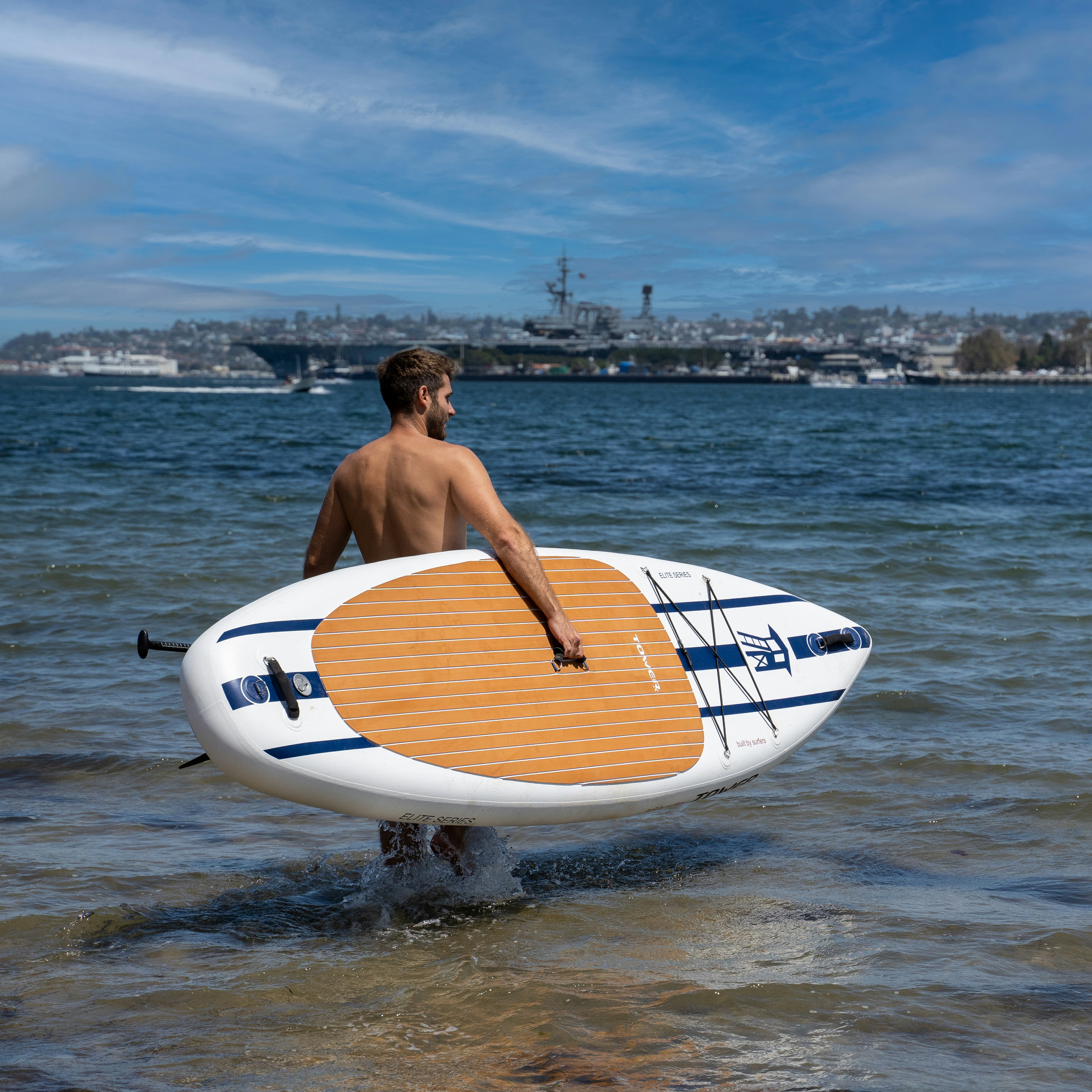 a man holding a surfboard in the water