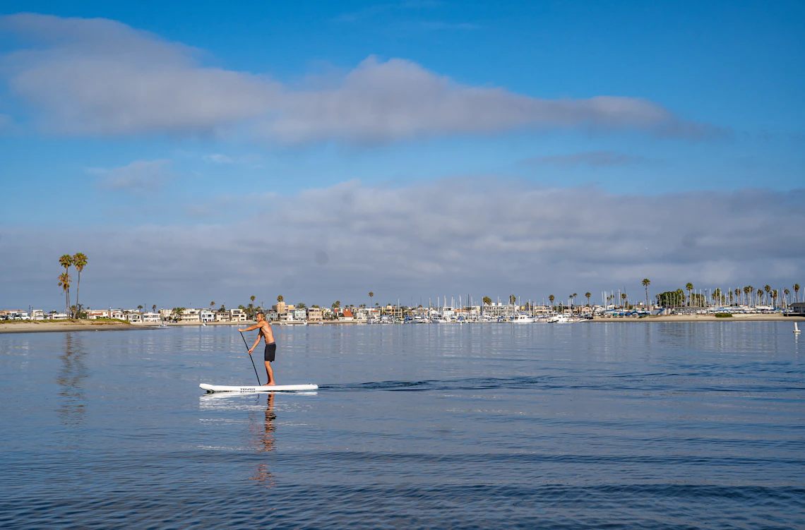 Paddle boarder on open water during a coastal outdoor session