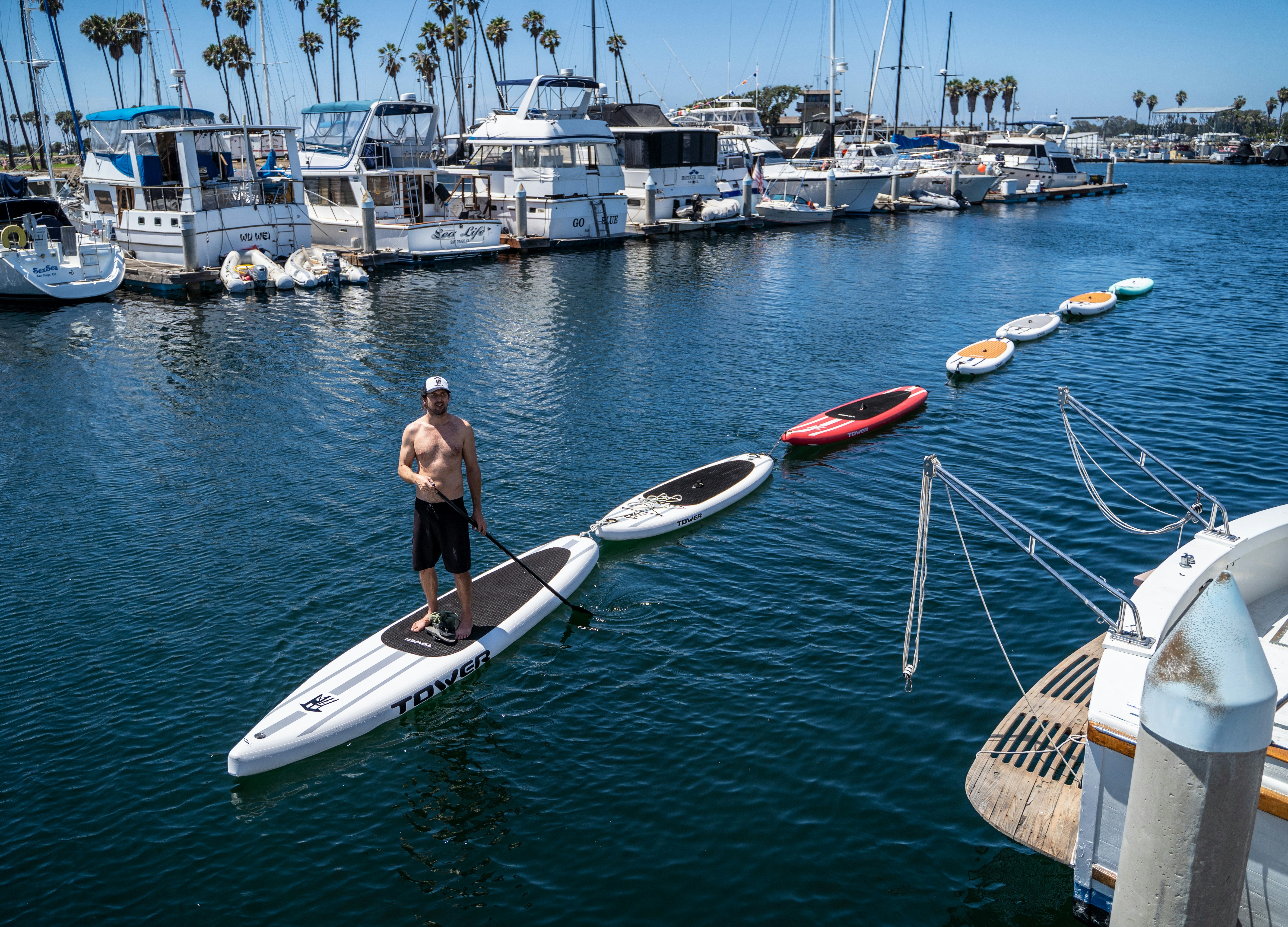 a man standing on a paddle board in the water