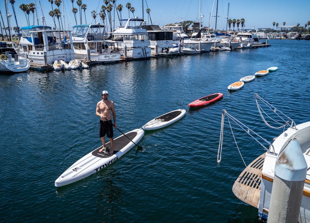 a man standing on a paddle board in the water