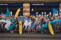 a group of people standing behind a fence
