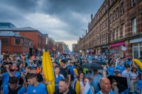 a large group of people walking down a street