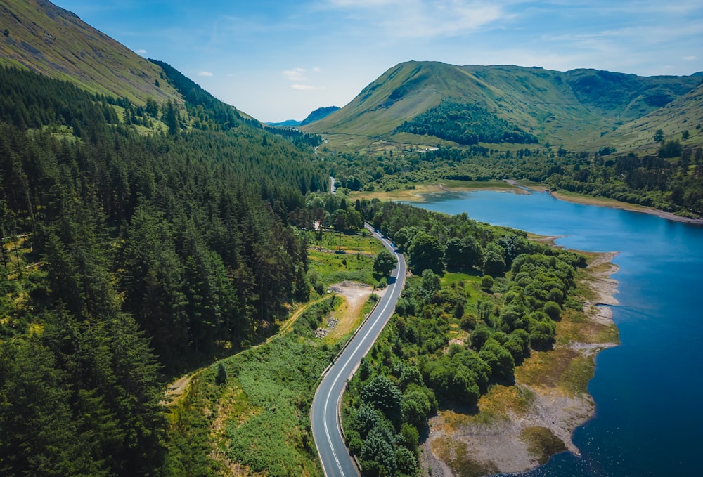 an aerial view of a winding road in the mountains