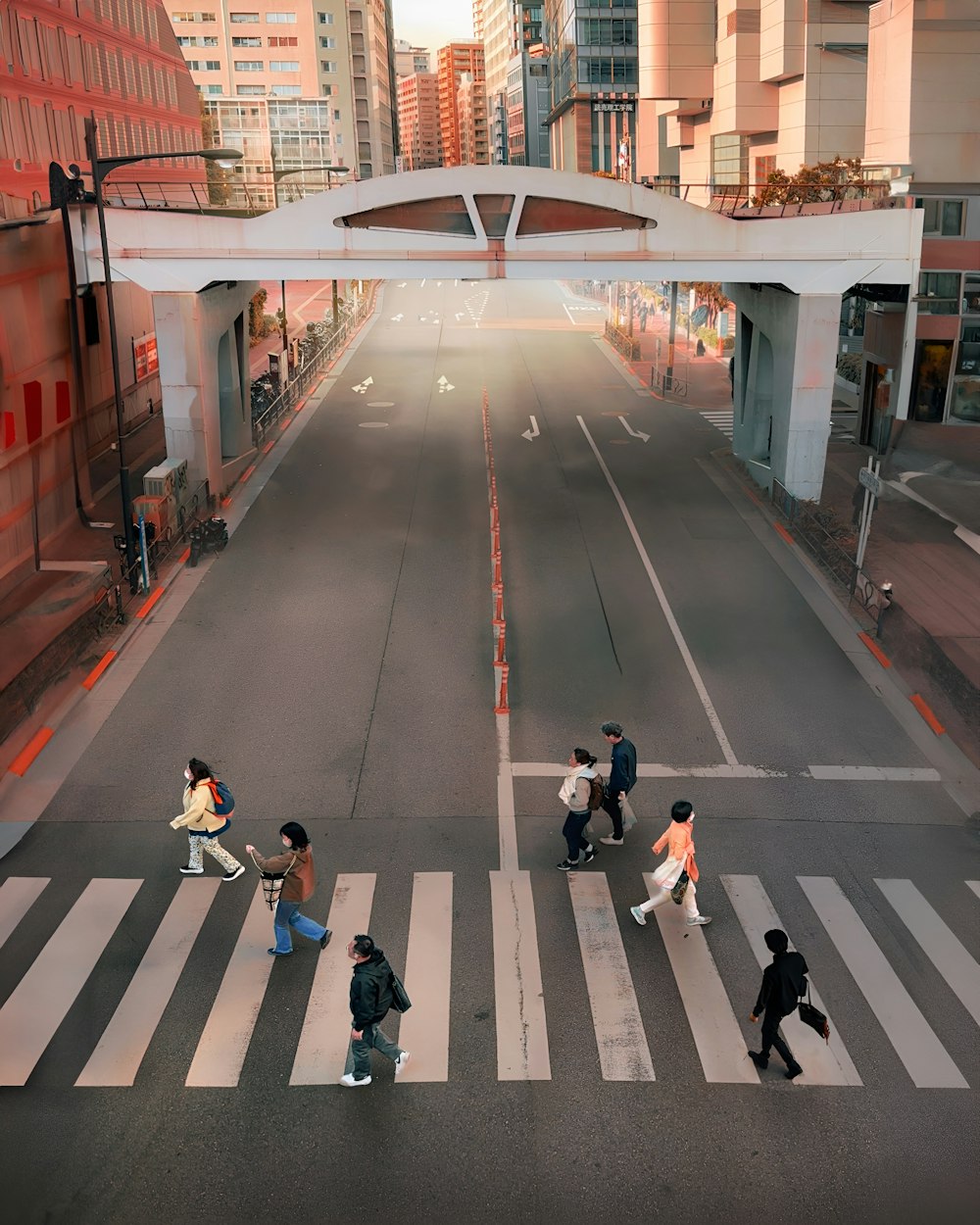 a group of people walking across a cross walk