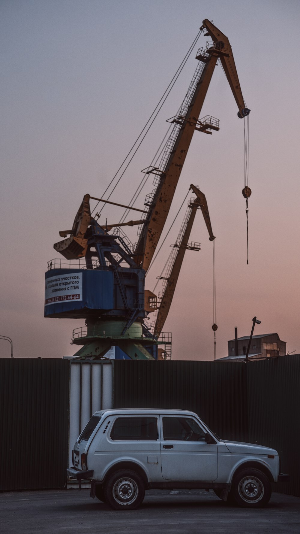 a truck is parked in front of a crane