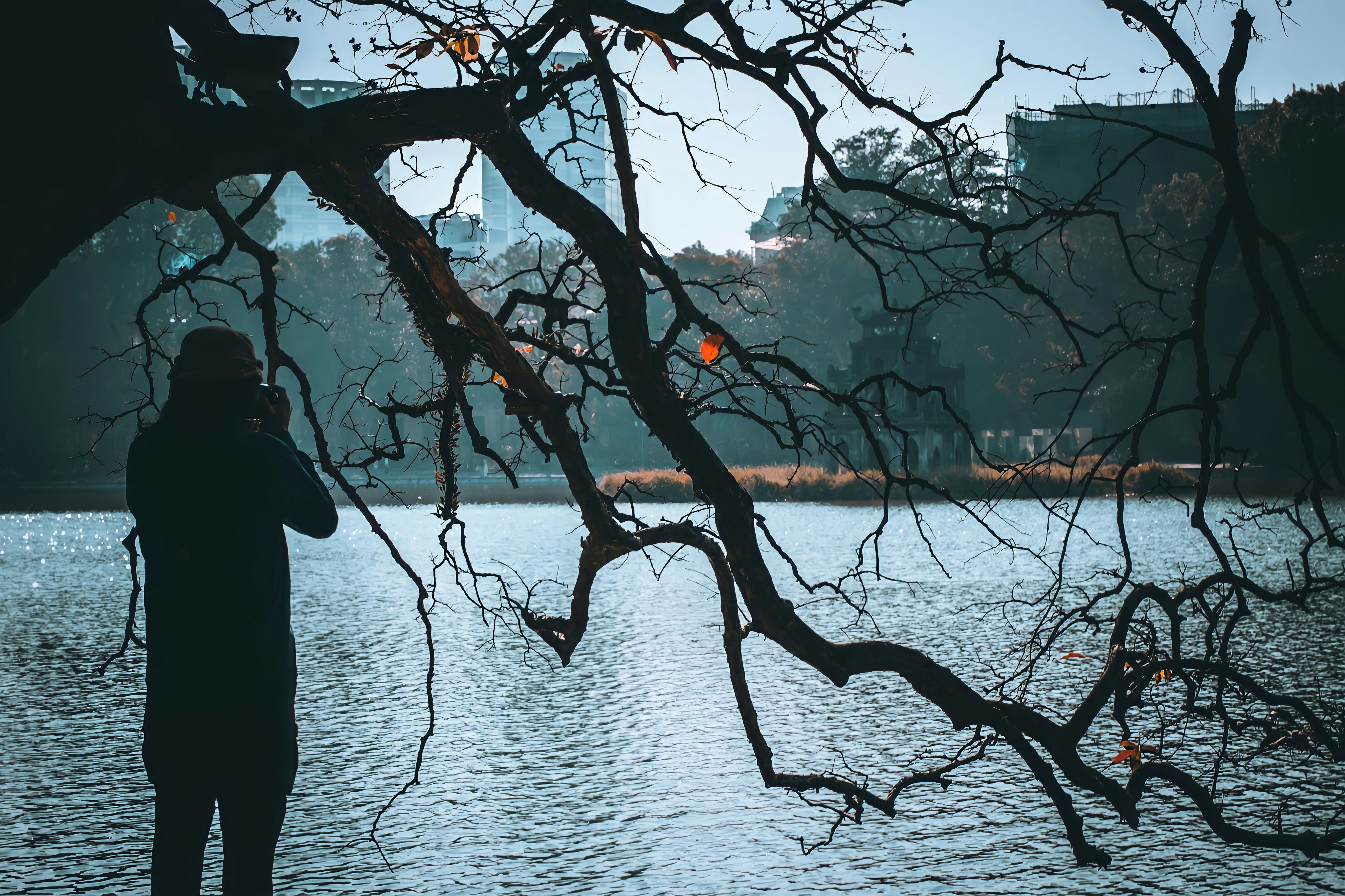 a person standing next to a body of water