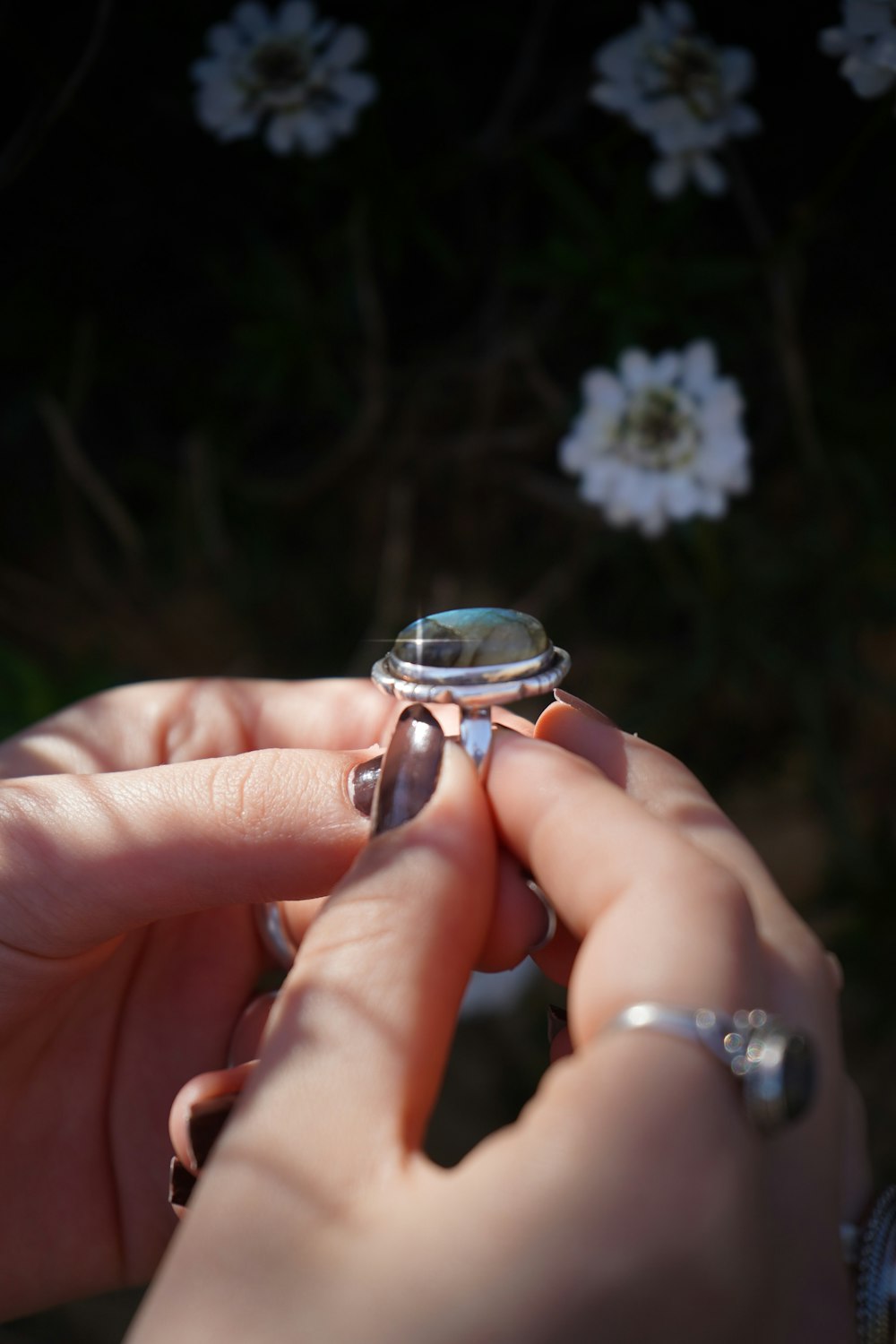 a woman holding a ring in her hand