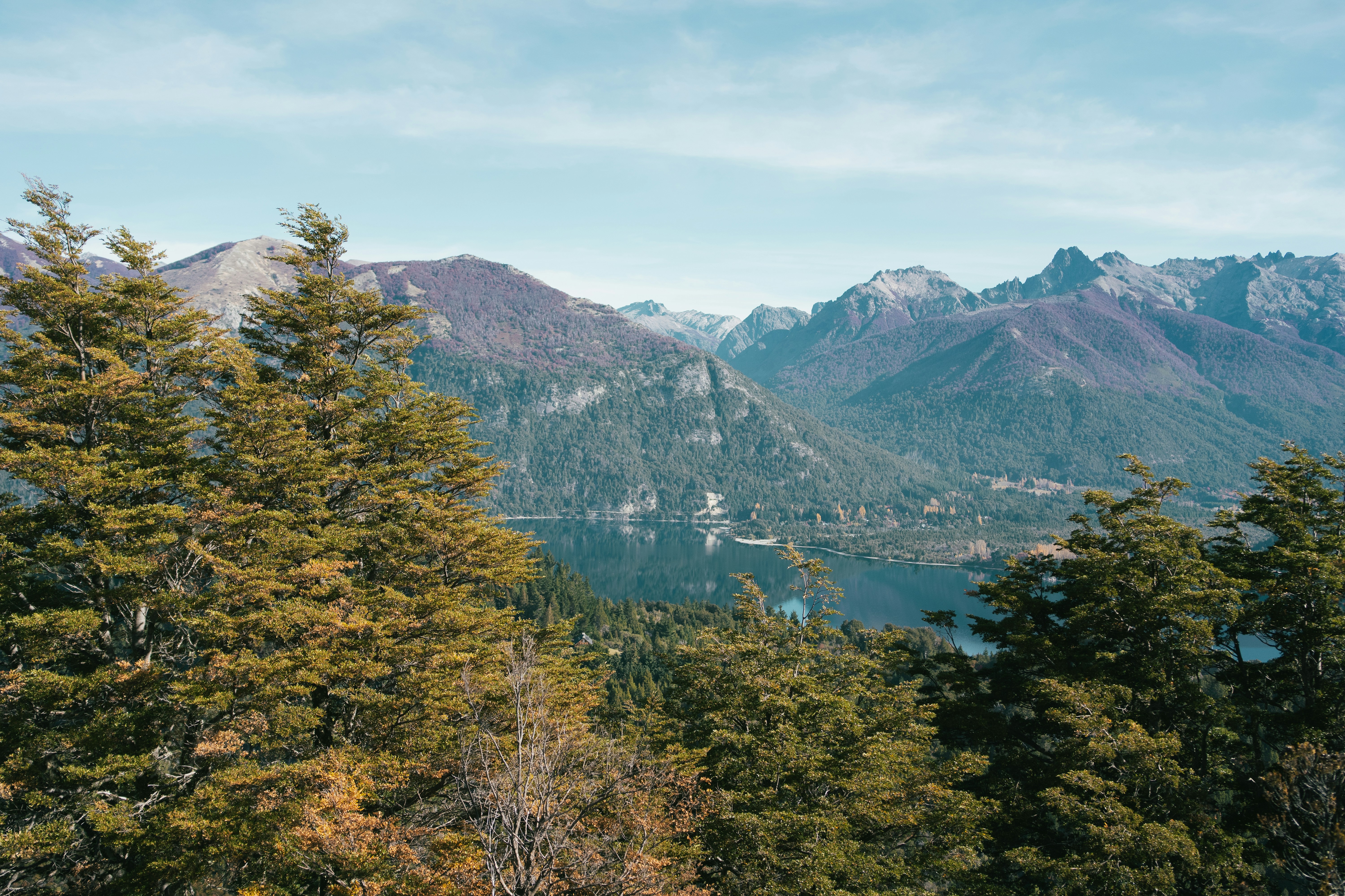 a scenic view of a lake surrounded by mountains