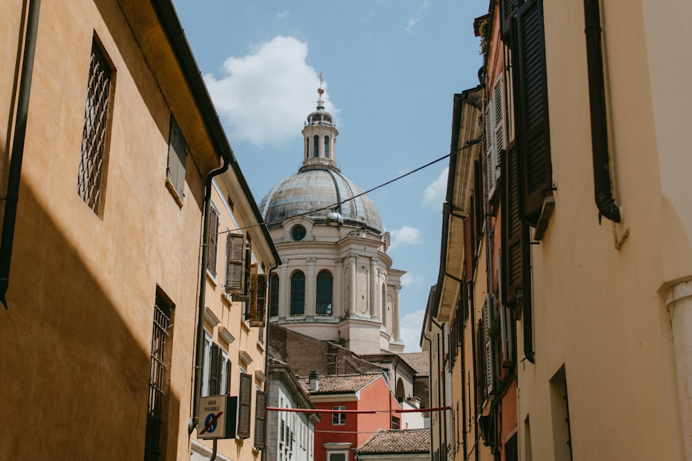 a narrow street with a church in the background