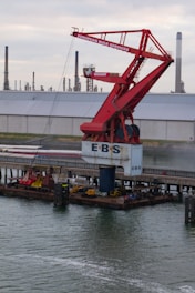 a crane is lifting a boat into the water