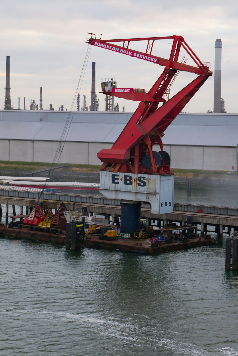 a crane is lifting a boat into the water