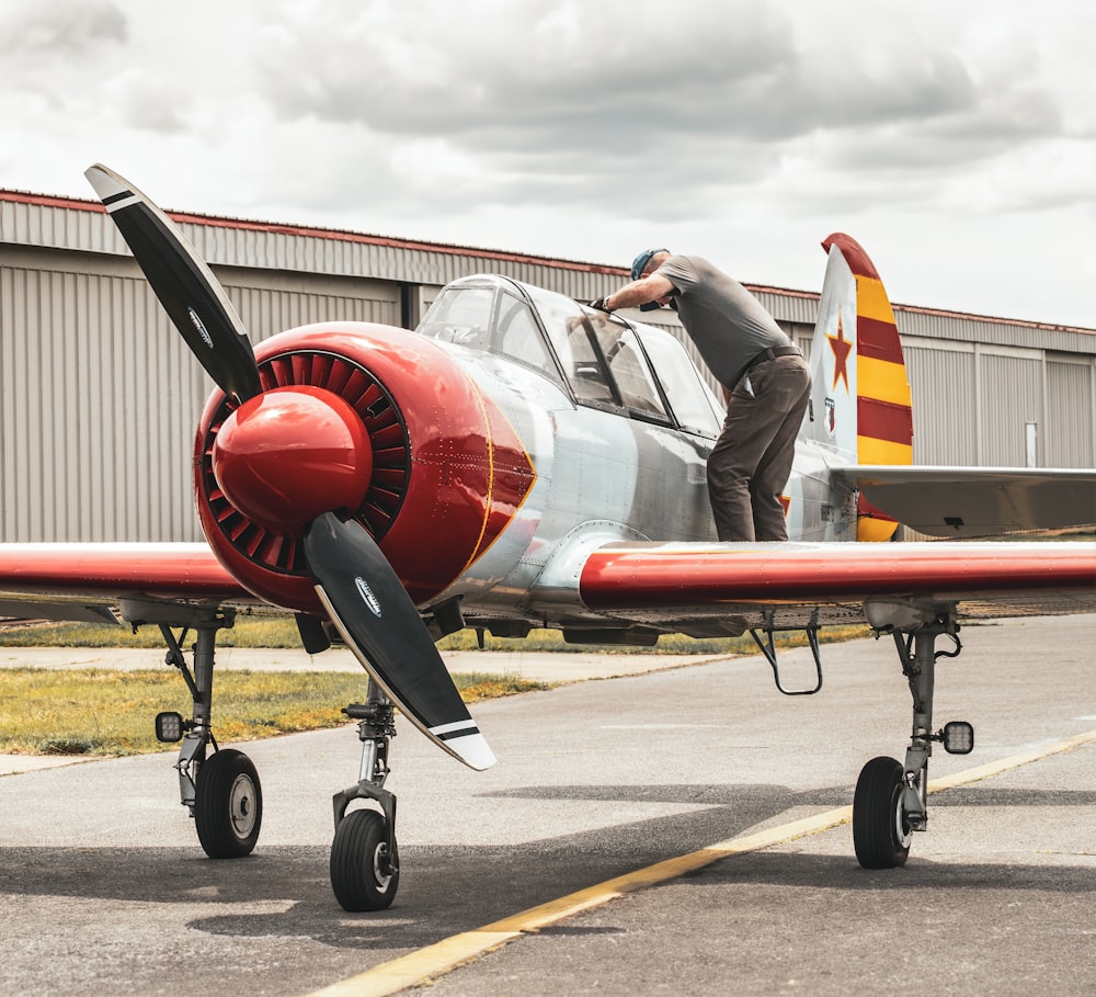 a man standing on the wing of an airplane