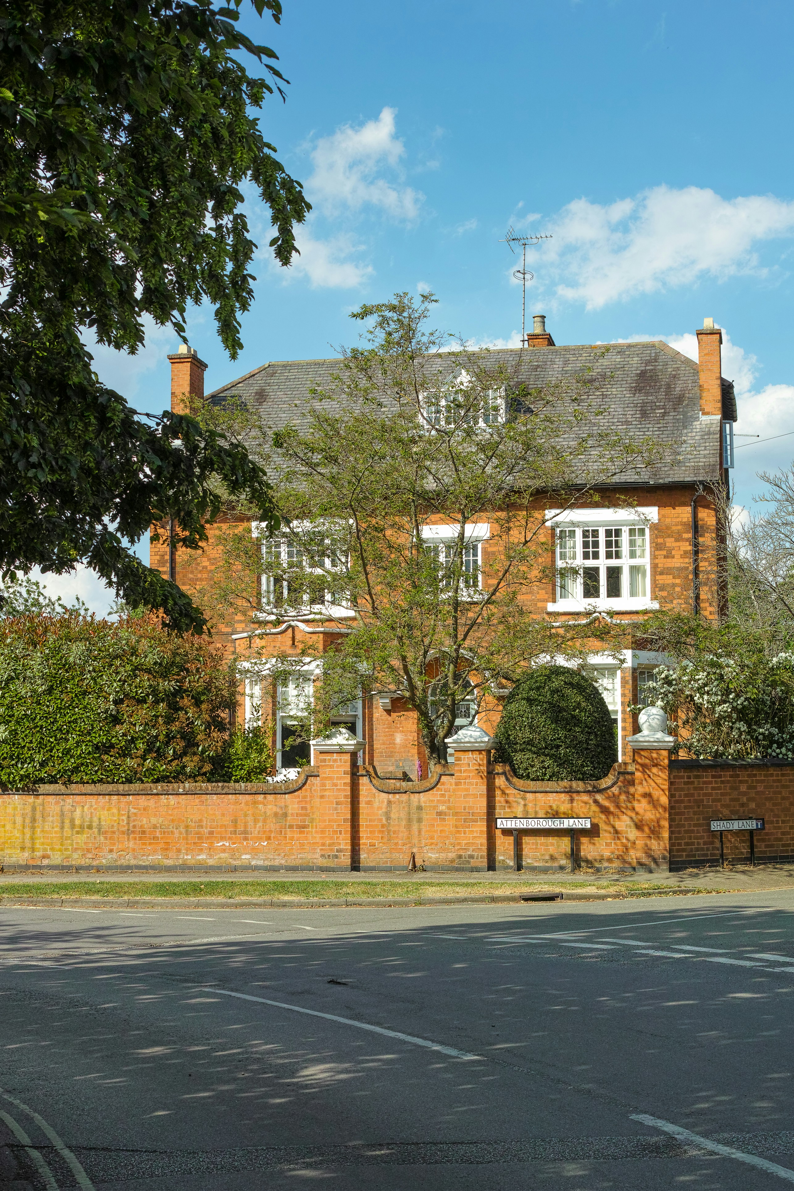 a large brick building with a tree in front of it